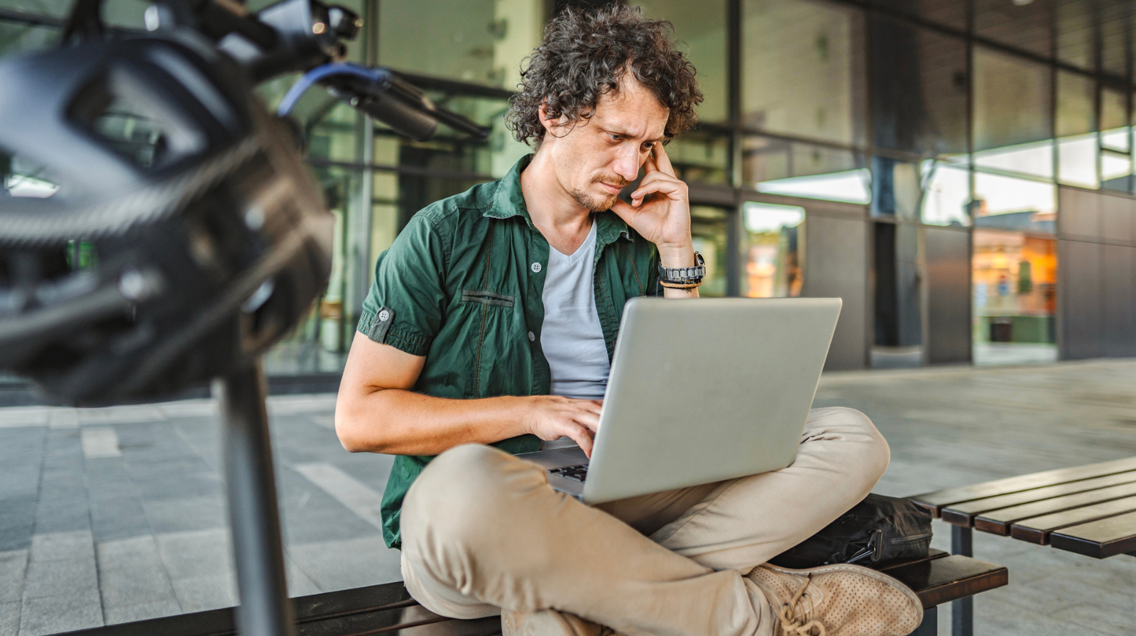 An anxious man staring at his laptop